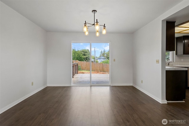 3812 R Ave, Anacortes, WA 98221 - unfurnished dining area with dark wood-style flooring, healthy amount of natural light, baseboards, and a sink