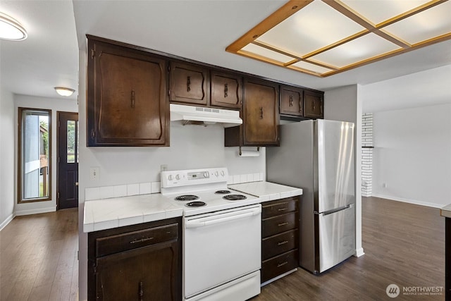 3812 R Ave, Anacortes, WA 98221 - kitchen featuring electric stove, under cabinet range hood, freestanding refrigerator, dark brown cabinetry, and tile countertops