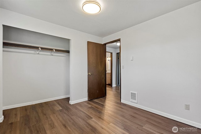 3812 R Ave, Anacortes, WA 98221 - unfurnished bedroom featuring a closet, wood finished floors, and baseboards