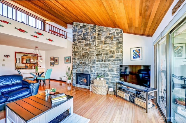 10 Olympic Pl Unit 10, Port Ludlow, WA 98365 - living room featuring wooden ceiling, wood-type flooring, a stone fireplace, and high vaulted ceiling