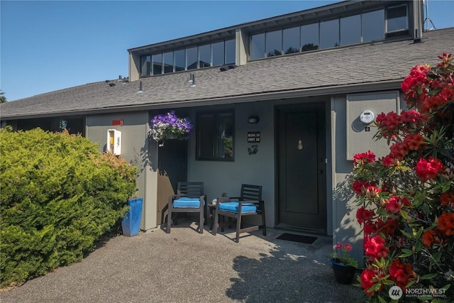10 Olympic Pl Unit 10, Port Ludlow, WA 98365 - back of house with roof with shingles and a porch