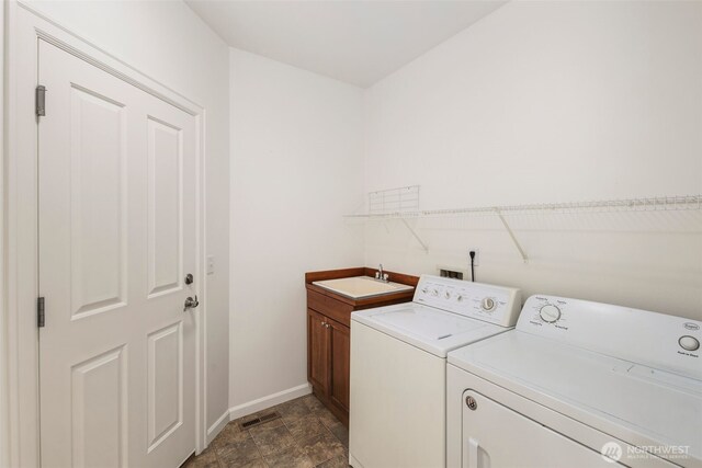 27424 NE 147th Ct, Duvall, WA 98019 - clothes washing area featuring independent washer and dryer, baseboards, cabinet space, and dark stone finish floors
