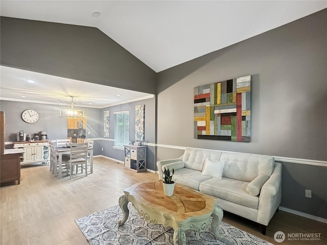 4207 Campus Green Loop NE, Lacey, WA 98516 - living area featuring light wood-style floors, vaulted ceiling, baseboards, and crown molding