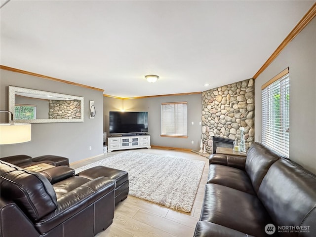 4207 Campus Green Loop NE, Lacey, WA 98516 - living area with crown molding, a stone fireplace, baseboards, and light wood-style floors