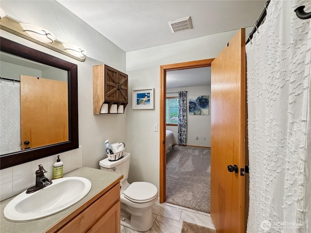4207 Campus Green Loop NE, Lacey, WA 98516 - bathroom featuring vanity, toilet, backsplash, and connected bathroom
