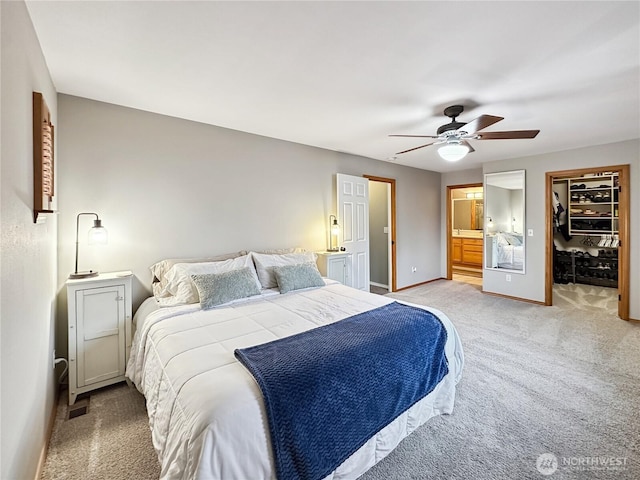 4207 Campus Green Loop NE, Lacey, WA 98516 - bedroom featuring light colored carpet, a ceiling fan, a walk in closet, baseboards, and connected bathroom