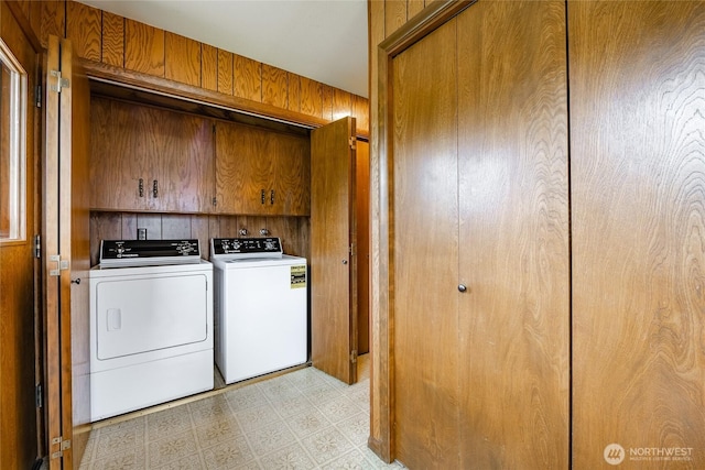 924 Pine St, Lynden, WA 98264 - laundry room with washing machine and clothes dryer, wooden walls, cabinet space, and light flooring