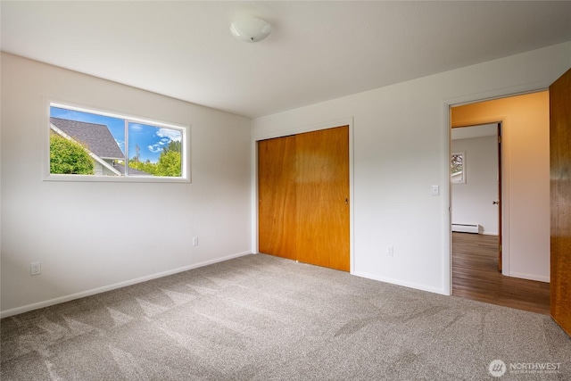 924 Pine St, Lynden, WA 98264 - unfurnished bedroom with carpet flooring, a baseboard radiator, baseboards, and a closet