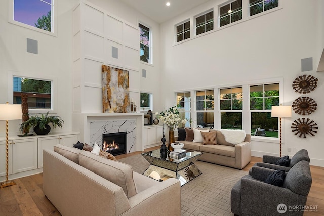 3976 154th Ave SE, Bellevue, WA 98006 - living area with a towering ceiling, a high end fireplace, light wood finished floors, plenty of natural light, and recessed lighting