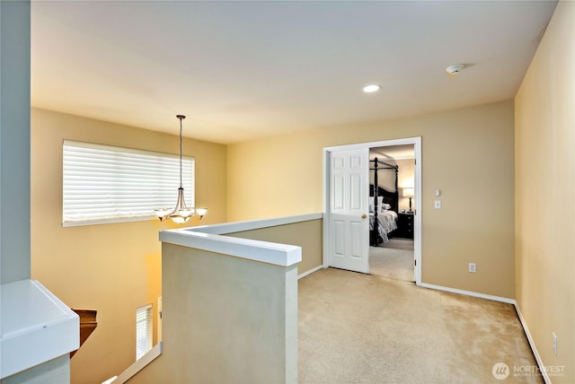 hall featuring an upstairs landing, light colored carpet, baseboards, a chandelier, and recessed lighting