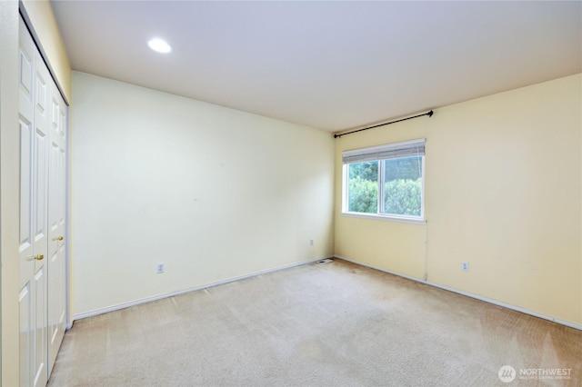 unfurnished bedroom with carpet, recessed lighting, a closet, and baseboards