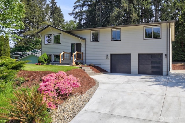 9630 SE Driftwood Dr, Port Orchard, WA 98367 - raised ranch featuring an attached garage and driveway