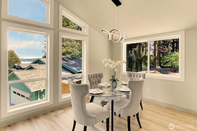 9630 SE Driftwood Dr, Port Orchard, WA 98367 - dining space with a chandelier, healthy amount of natural light, and wood finished floors