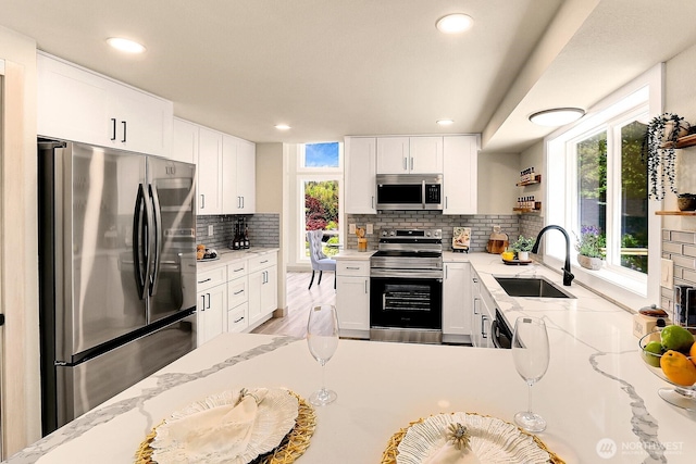 9630 SE Driftwood Dr, Port Orchard, WA 98367 - kitchen featuring stainless steel appliances, a sink, healthy amount of natural light, tasteful backsplash, and recessed lighting