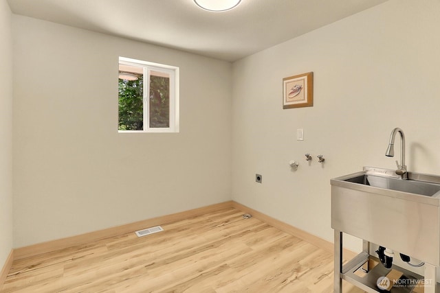 9630 SE Driftwood Dr, Port Orchard, WA 98367 - laundry room featuring electric dryer hookup, light wood-style floors, baseboards, and hookup for a washing machine