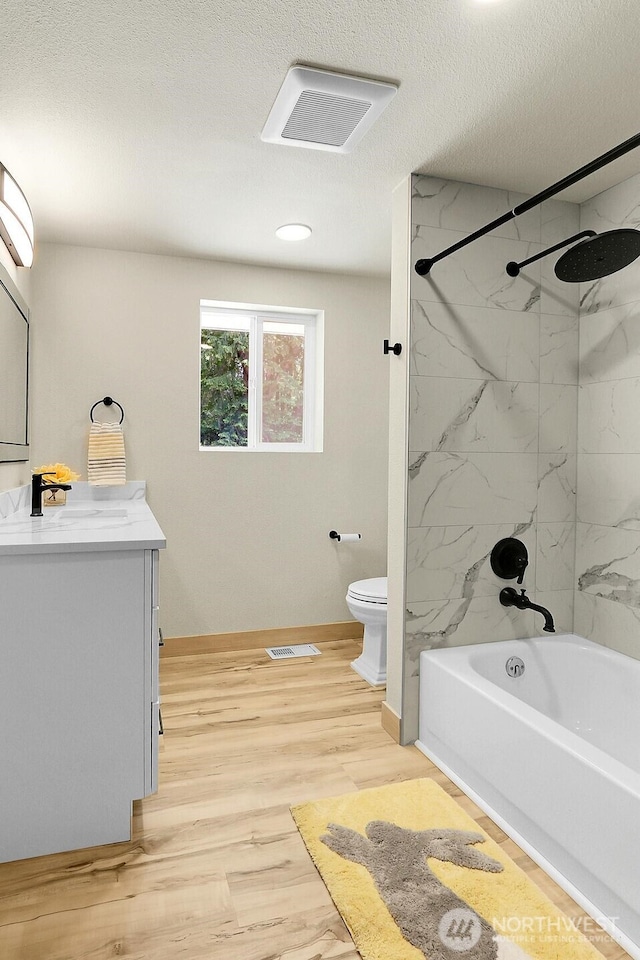 9630 SE Driftwood Dr, Port Orchard, WA 98367 - full bath featuring baseboards, toilet, vanity, bathing tub / shower combination, and wood finished floors