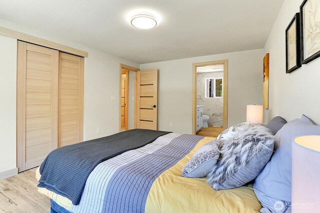 9630 SE Driftwood Dr, Port Orchard, WA 98367 - bedroom with light wood-style floors, a closet, and connected bathroom