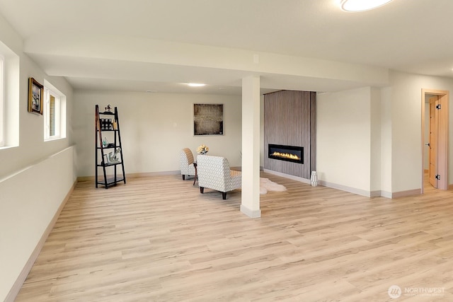 9630 SE Driftwood Dr, Port Orchard, WA 98367 - living room with light wood finished floors, a fireplace, and baseboards