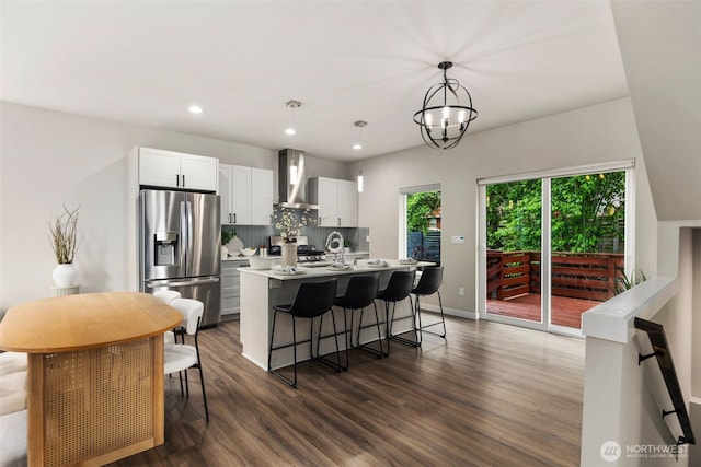 5126 S Creston St, Seattle, WA 98178 - kitchen with stainless steel fridge with ice dispenser, wall chimney range hood, a center island with sink, dark wood-type flooring, and tasteful backsplash