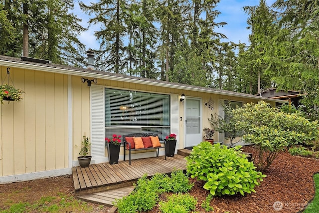 property entrance with a wooden deck and outdoor lounge area
