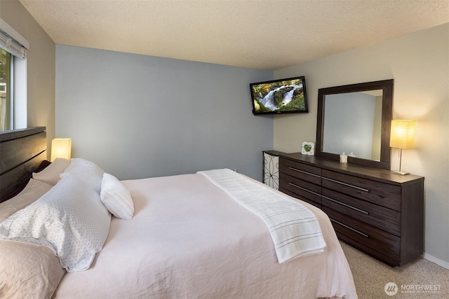 bedroom featuring light carpet and baseboards