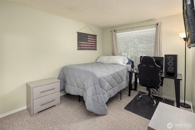 carpeted bedroom with a textured ceiling and baseboards
