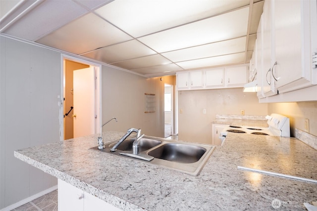 3701 Gun Club Rd Unit 16, Yakima, WA 98901 - kitchen featuring white electric range, a sink, light countertops, white cabinets, and a paneled ceiling