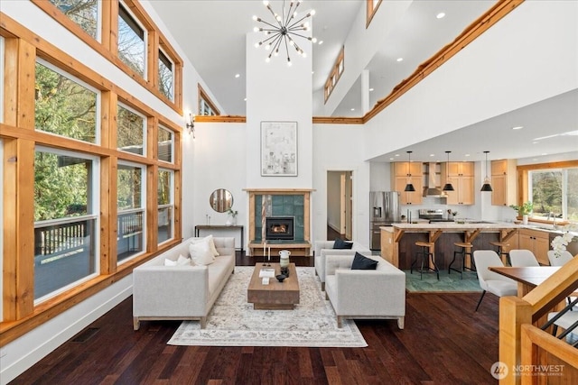 8607 436th Ave SE, North Bend, WA 98045 - living room with a high ceiling, dark wood-style floors, a tile fireplace, recessed lighting, and a chandelier