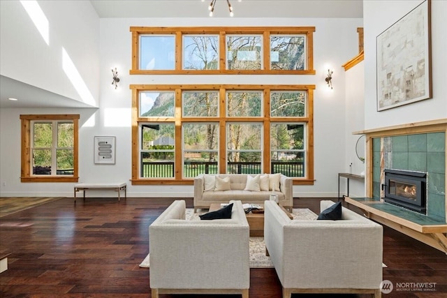 8607 436th Ave SE, North Bend, WA 98045 - living room with a high ceiling, wood finished floors, baseboards, and a fireplace