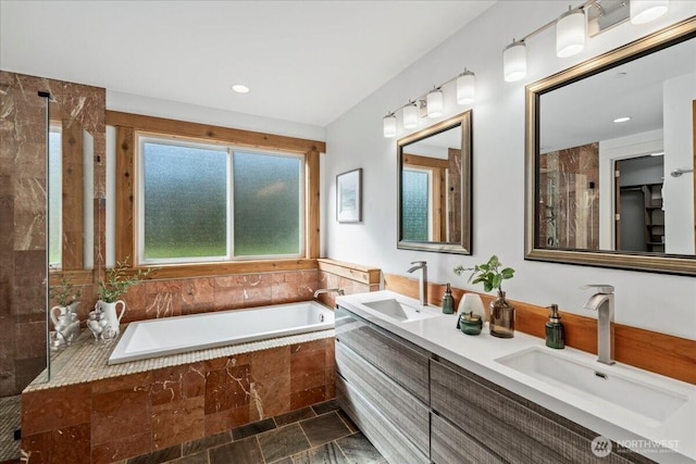 8607 436th Ave SE, North Bend, WA 98045 - full bath featuring a bath, stone finish flooring, double vanity, and recessed lighting