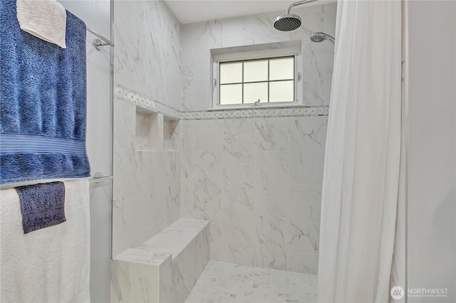 bathroom with tiled shower