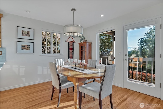 dining space featuring light wood-style floors, healthy amount of natural light, baseboards, recessed lighting, and a chandelier