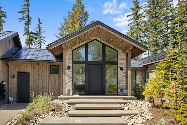 1501 Kokanee Loop, Cle Elum, WA 98922 - property entrance featuring a standing seam roof, metal roof, and stone siding