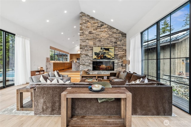 1501 Kokanee Loop, Cle Elum, WA 98922 - living area featuring high vaulted ceiling, wood finished floors, healthy amount of natural light, a fireplace, and recessed lighting