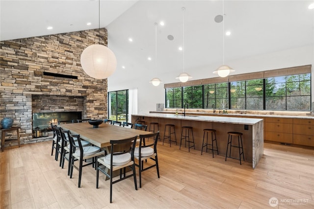 1501 Kokanee Loop, Cle Elum, WA 98922 - dining area with high vaulted ceiling, light wood-style floors, and a stone fireplace