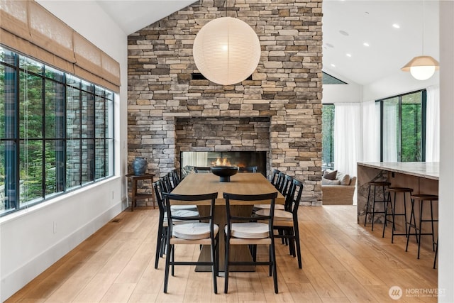 1501 Kokanee Loop, Cle Elum, WA 98922 - dining space with high vaulted ceiling, light wood-type flooring, and a stone fireplace