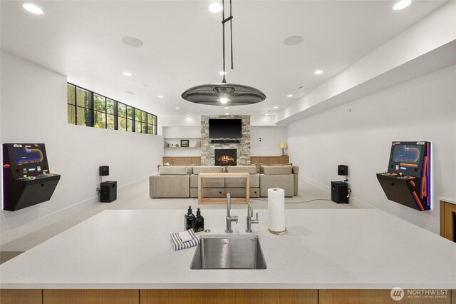 1501 Kokanee Loop, Cle Elum, WA 98922 - kitchen featuring a sink, recessed lighting, a stone fireplace, baseboards, and open floor plan