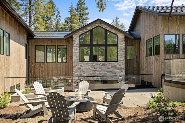 1501 Kokanee Loop, Cle Elum, WA 98922 - rear view of house with a fire pit, a patio area, and stone siding
