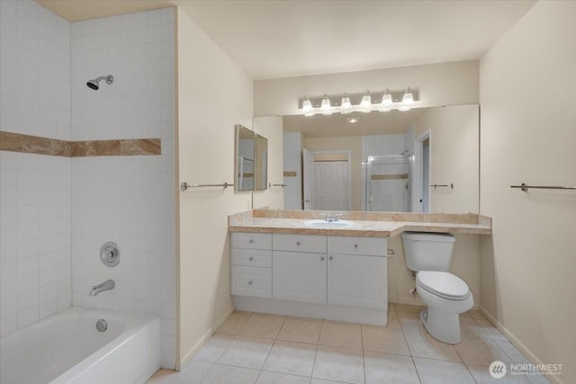 full bath with tile patterned flooring, toilet, baseboards, vanity, and tub / shower combination