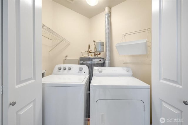 washroom with independent washer and dryer and water heater