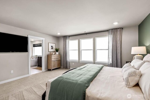 11434 SE 84th St Unit 34, Newcastle, WA 98056 - bedroom featuring multiple windows, light colored carpet, baseboards, recessed lighting, and connected bathroom