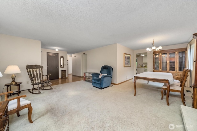 carpeted living area featuring a chandelier, baseboards, and a textured ceiling