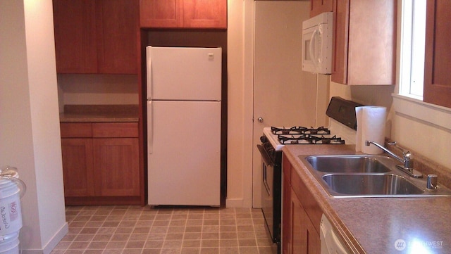 4815 S J St, Tacoma, WA 98408 - kitchen with white appliances, a sink, and brown cabinets
