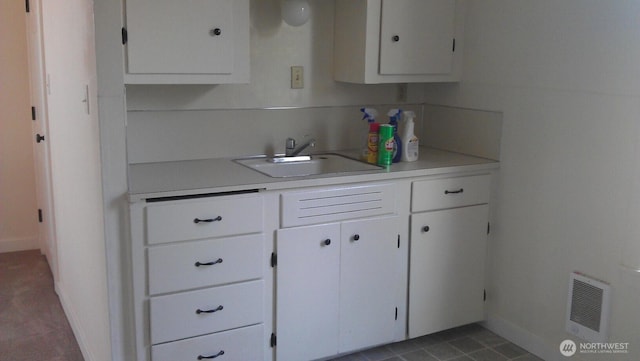 4815 S J St, Tacoma, WA 98408 - kitchen featuring a sink, light countertops, white cabinetry, and baseboards