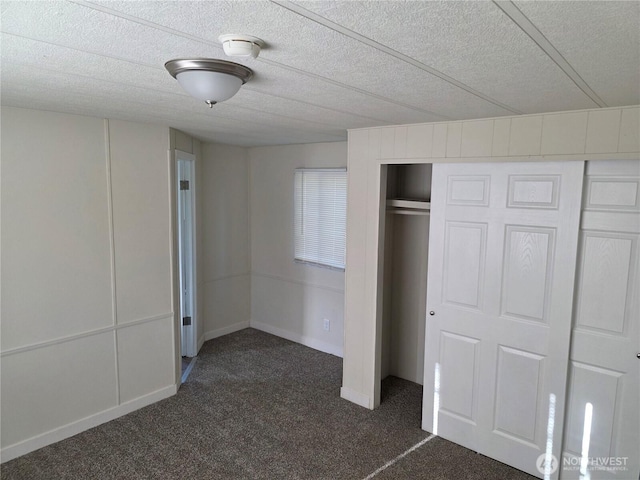 17925 Jordan St SW, Rochester, WA 98579 - unfurnished bedroom featuring dark colored carpet, a closet, and a textured ceiling