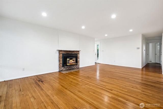 35010 45th Ave S, Auburn, WA 98001 - unfurnished living room with light wood-style flooring, recessed lighting, a fireplace, and baseboards