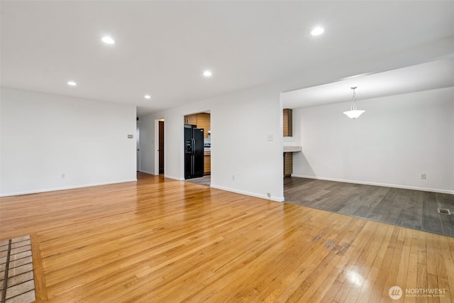 35010 45th Ave S, Auburn, WA 98001 - unfurnished living room featuring light wood finished floors, recessed lighting, and baseboards