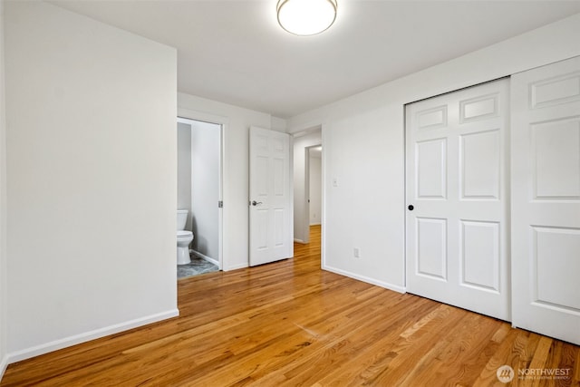 35010 45th Ave S, Auburn, WA 98001 - unfurnished bedroom featuring light wood-style floors, baseboards, a closet, and connected bathroom