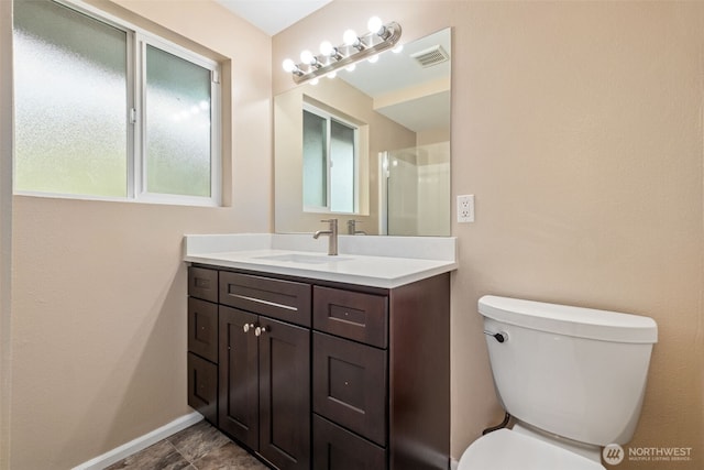 35010 45th Ave S, Auburn, WA 98001 - full bathroom with toilet, vanity, a shower with shower door, and baseboards