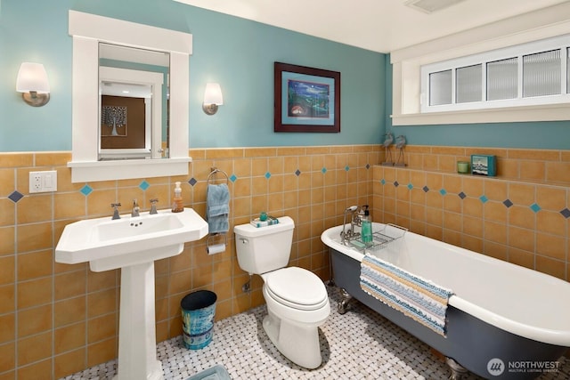 1712 Arch Ave SW, Seattle, WA 98116 - full bathroom with toilet, tile walls, a freestanding tub, and wainscoting